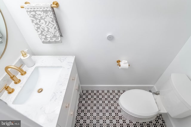 bathroom with tile patterned flooring, toilet, and vanity