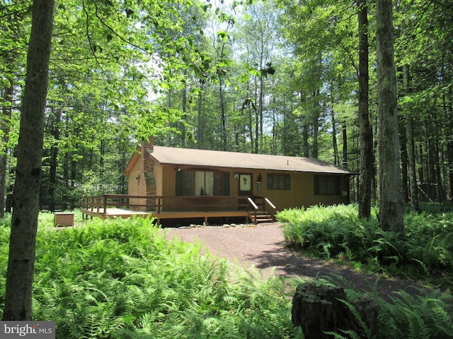 view of front of property with a wooden deck