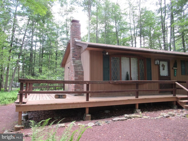 back of property with a wooden deck