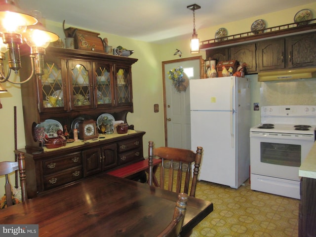 kitchen featuring dark brown cabinetry, white appliances, and hanging light fixtures