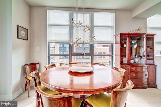 dining room with light tile patterned floors, expansive windows, and a wealth of natural light