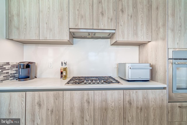 kitchen with light brown cabinetry and stainless steel appliances