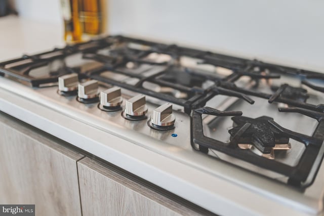 details with light brown cabinets and gas cooktop