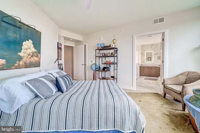 carpeted bedroom featuring ensuite bathroom and ceiling fan