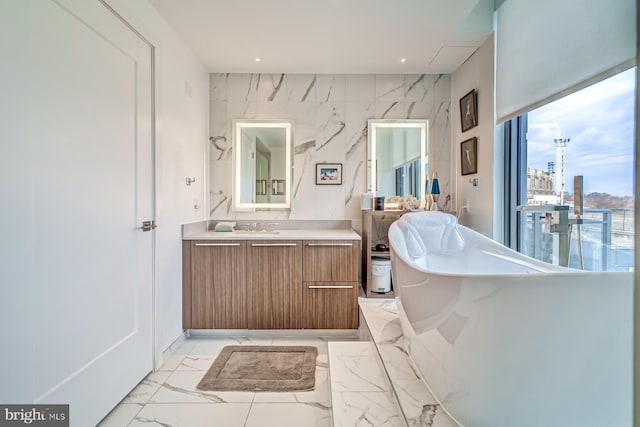 bathroom with a washtub and vanity