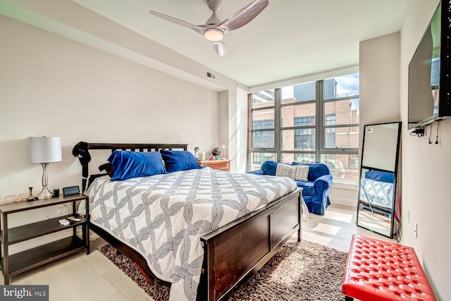 bedroom with ceiling fan and light hardwood / wood-style floors