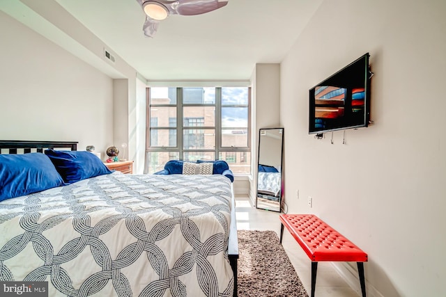 bedroom featuring expansive windows and ceiling fan