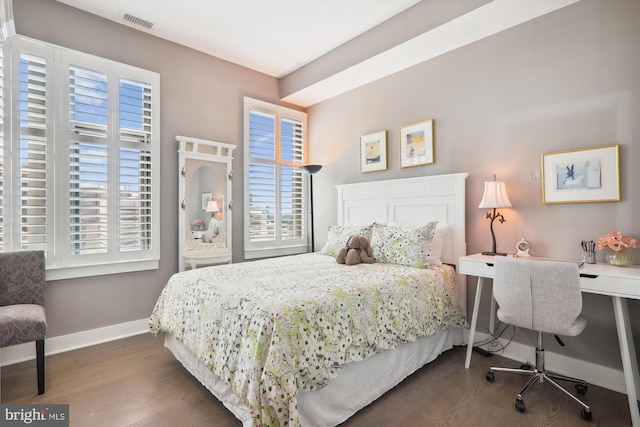 bedroom with dark hardwood / wood-style flooring