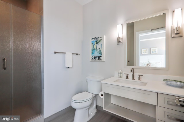 bathroom with a shower with door, hardwood / wood-style flooring, toilet, and vanity