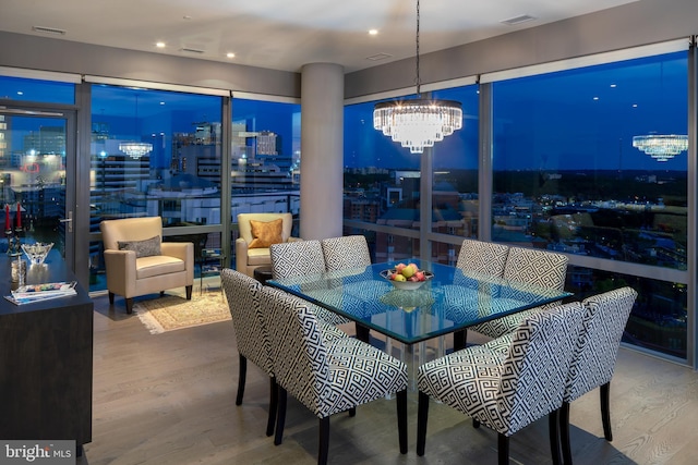 dining room featuring an inviting chandelier and hardwood / wood-style flooring