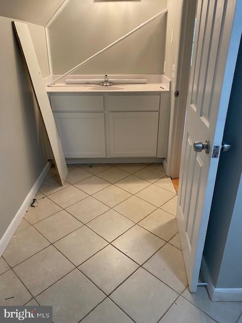 bathroom with tile patterned flooring and vanity