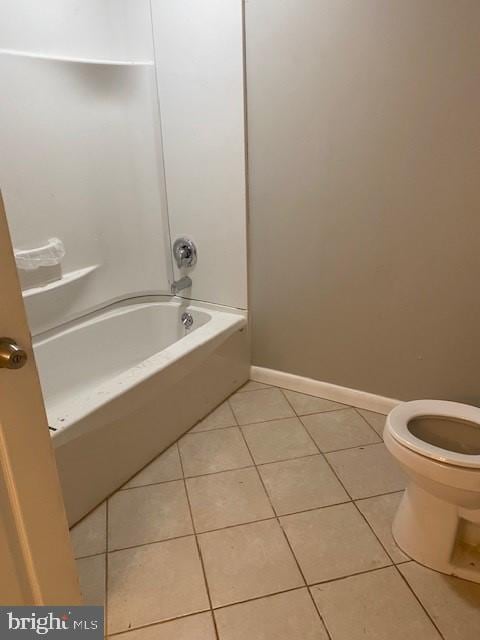 bathroom featuring tile patterned flooring, toilet, and shower / bathing tub combination