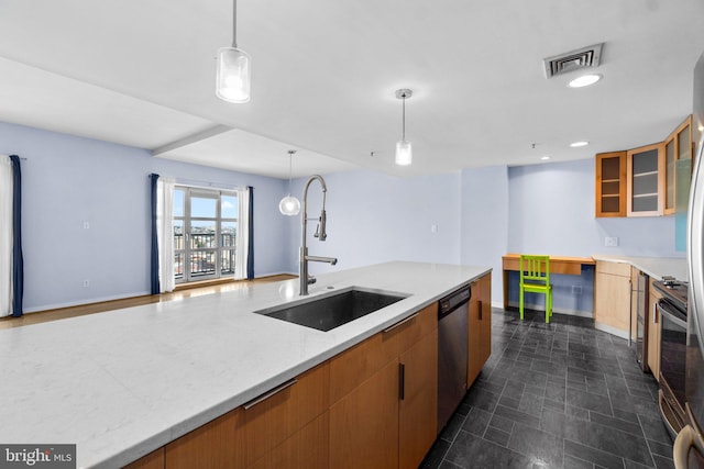 kitchen with light stone countertops, sink, hanging light fixtures, and dishwasher