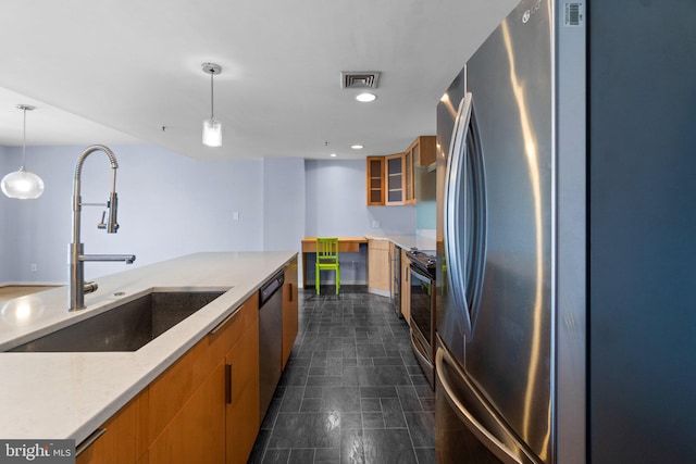 kitchen featuring light stone countertops, sink, hanging light fixtures, and appliances with stainless steel finishes