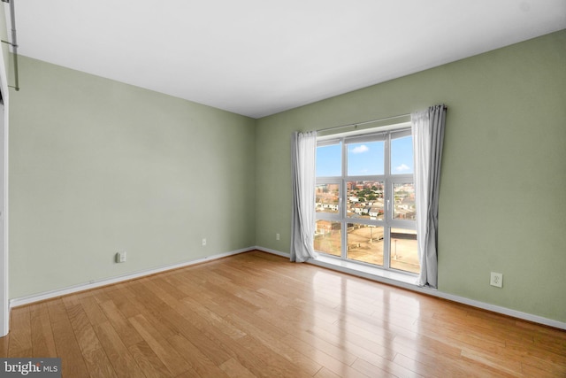 unfurnished room with light hardwood / wood-style flooring