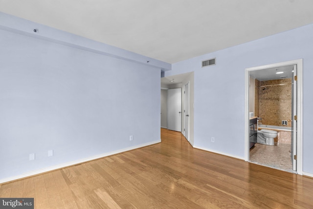 spare room with light hardwood / wood-style flooring