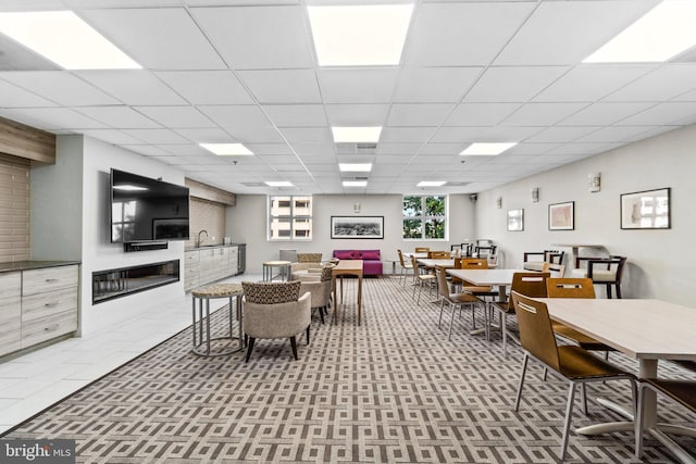 dining space featuring a drop ceiling and sink