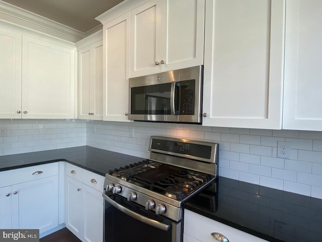 kitchen featuring decorative backsplash, stainless steel appliances, and white cabinetry