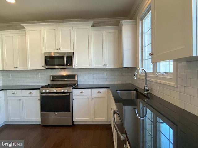 kitchen with white cabinetry, sink, and appliances with stainless steel finishes