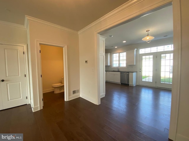 interior space featuring dark hardwood / wood-style flooring, sink, and ornamental molding