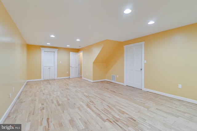 bonus room with light wood-type flooring