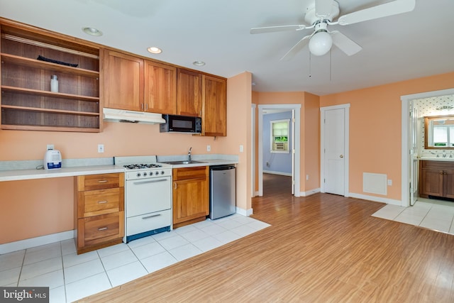 kitchen with sink, stainless steel dishwasher, ceiling fan, white gas stove, and light hardwood / wood-style floors