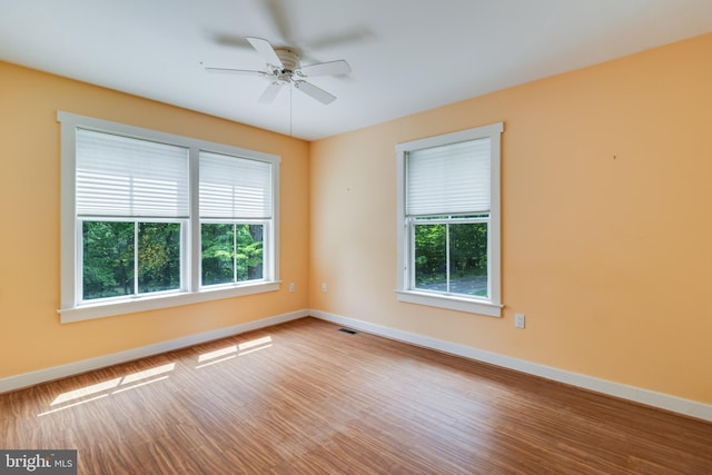 unfurnished room with hardwood / wood-style floors and ceiling fan