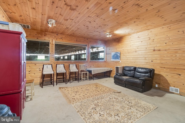 living room featuring wooden ceiling and wooden walls