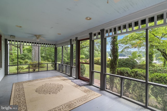 unfurnished sunroom featuring ceiling fan