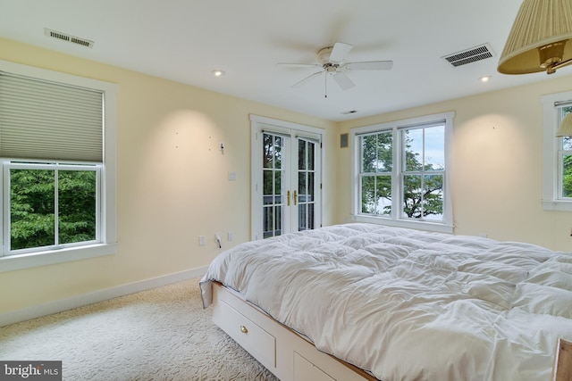 bedroom with access to exterior, ceiling fan, french doors, and light carpet