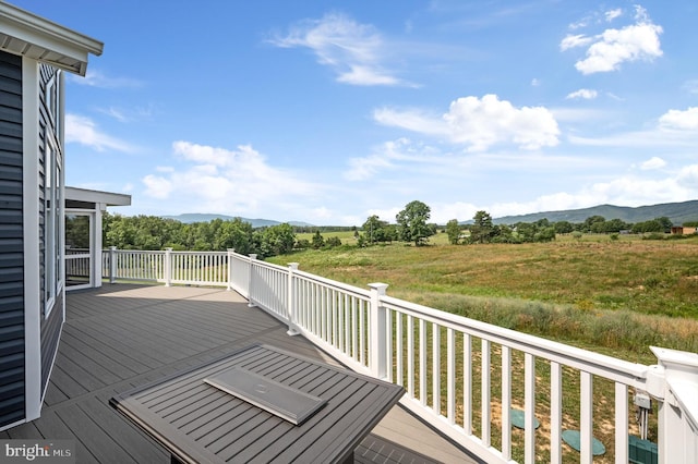 wooden deck featuring a mountain view and a rural view