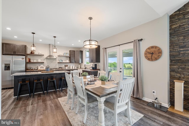 dining area with lofted ceiling, dark wood-type flooring, and french doors