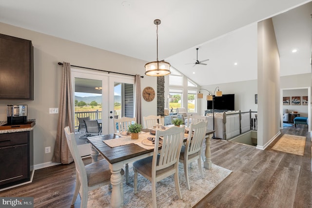 dining area featuring french doors, vaulted ceiling, ceiling fan, and dark wood-type flooring