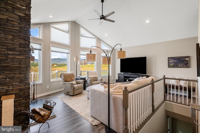 living room featuring hardwood / wood-style flooring, ceiling fan, and high vaulted ceiling