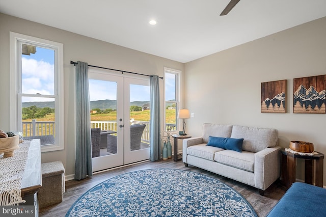 living room with dark hardwood / wood-style flooring, a mountain view, french doors, and ceiling fan