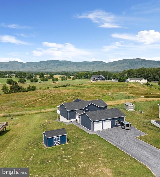 drone / aerial view with a mountain view and a rural view