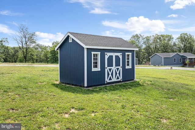 view of outdoor structure with a lawn