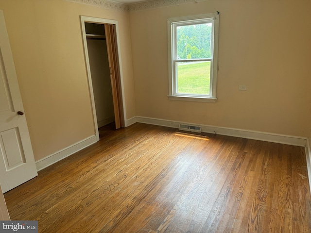 unfurnished bedroom featuring a closet and light hardwood / wood-style floors