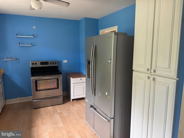 kitchen with stainless steel appliances, ceiling fan, and light hardwood / wood-style floors