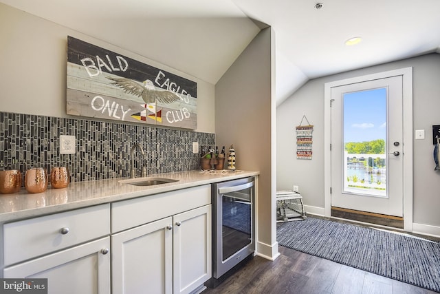 bar with lofted ceiling, dark wood-type flooring, white cabinets, sink, and wine cooler