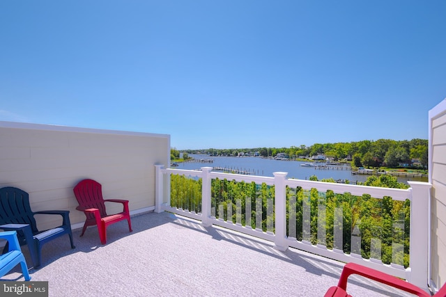 view of patio with a water view and a balcony