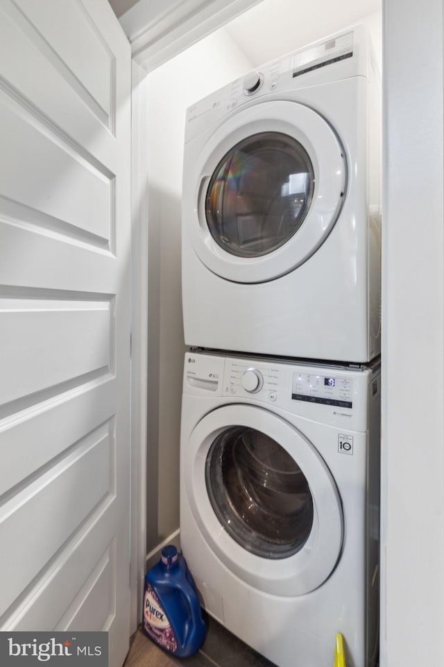 laundry area with stacked washer / dryer