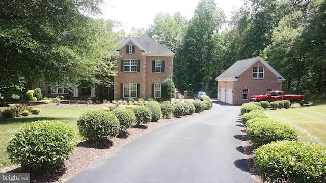 view of front of property with a garage and a front lawn