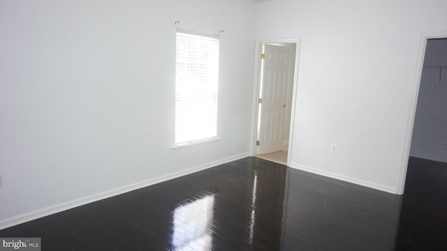 unfurnished room with dark hardwood / wood-style floors