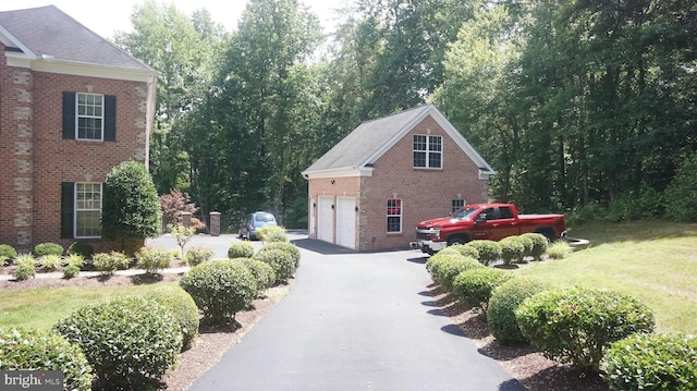 view of side of property with a lawn and a garage