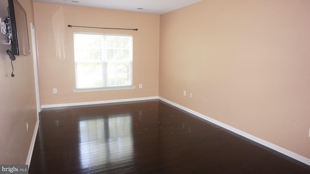 unfurnished room featuring dark hardwood / wood-style flooring