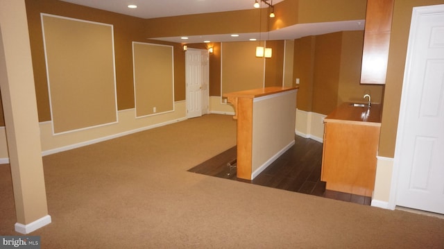 interior space with dark colored carpet and sink