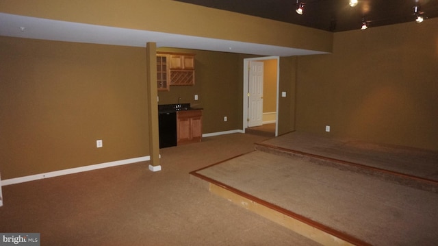 basement with dark carpet and bar area