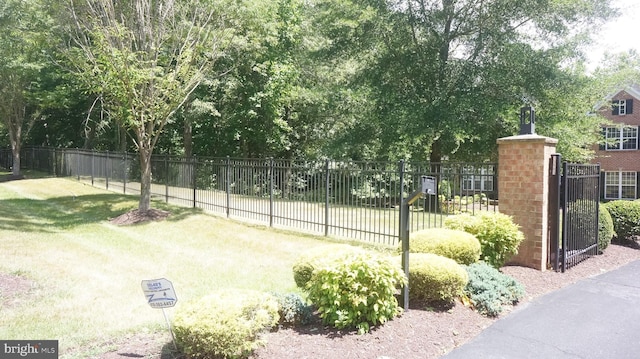 view of tennis court with a yard