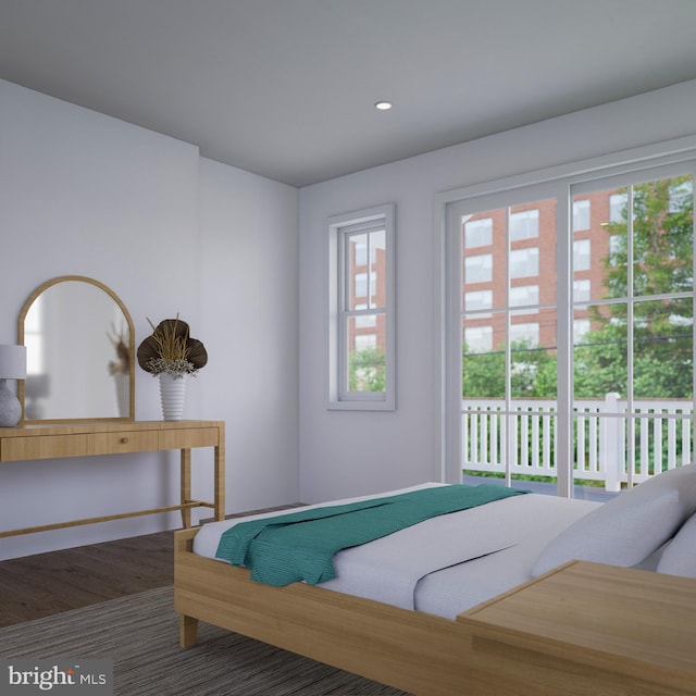 bedroom with wood-type flooring and access to exterior